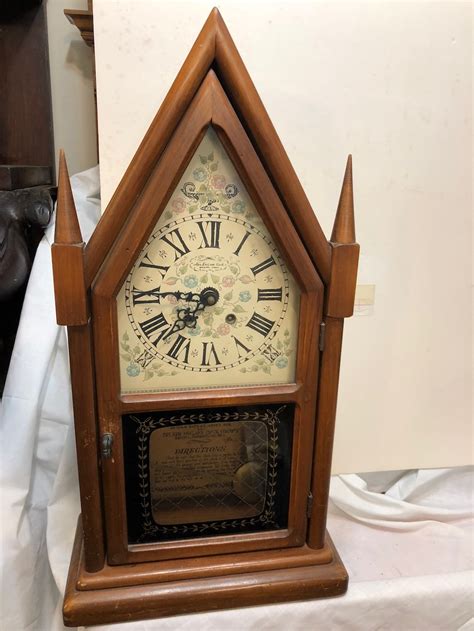 A New England Clock Company of Bristol Connecticut Key Wind Wall Clock in good working condition this Beautiful Clock is made of Oak, it has a small crack at the corner of Glass not very visible and it measures 18 18 inches in height 12 12 inches wide and 3 12 inches thick and weights 3 Pounds. . New england clock company